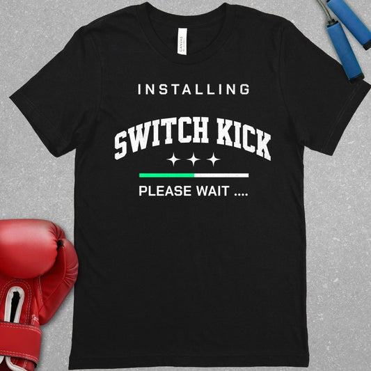 Black shirt with white writing that says INSTALLING SWITCH KICK PLEASE WAIT.