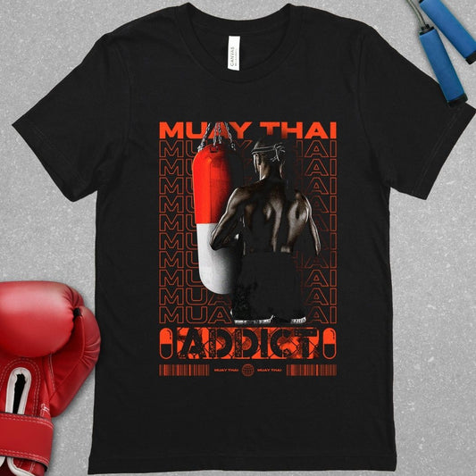 Black shirt with a design that says Muay Thai addict and it has a picture of a Muay Thai fighter facing a Muay Thai bag.