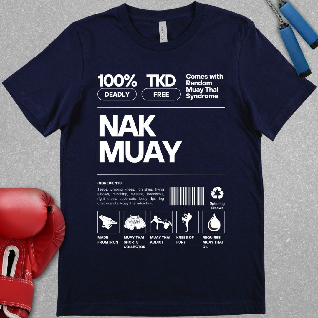 Navy shirt with a design that represents a nutrition label but relates it to Muay Thai. There is an ingredients list stating that teeps, knees, head kicks and other Muay Thai strikes are included. It also includes a barcode. All text is White.