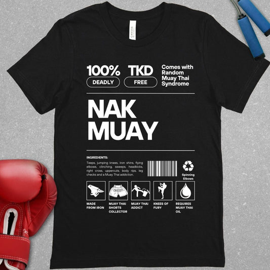 Black shirt with a design that represents a nutrition label but relates it to Muay Thai. There is an ingredients list stating that teeps, knees, head kicks and other Muay Thai strikes are included. It also includes a barcode. All text is White.