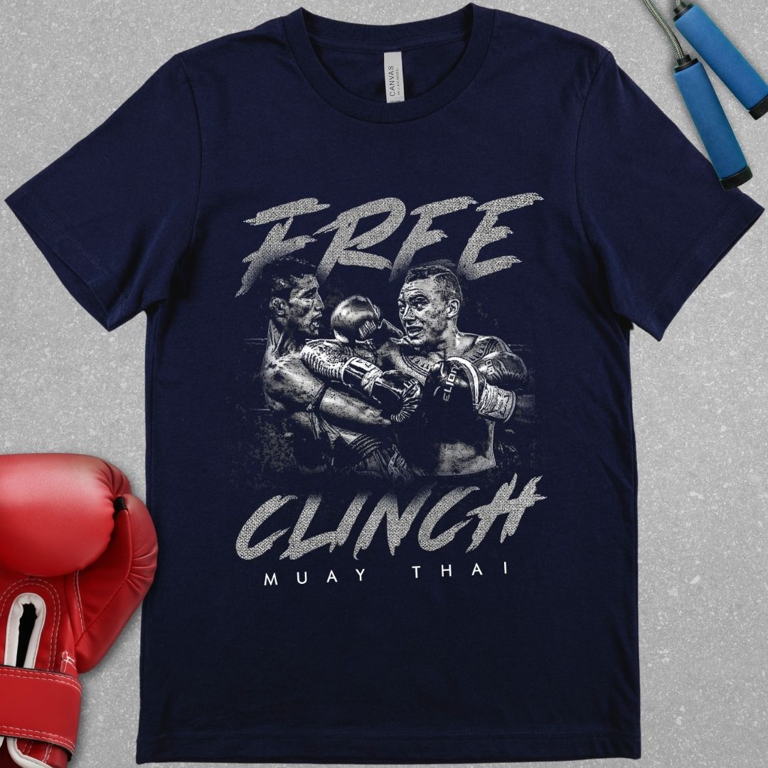 Navy t-shirt that has a design of two Muay Thai fighters clinching with one of the Muay Thai fighters throwing an elbow in the clinch. The design also contains the phrase Free Clinch and has the words Muay Thai at the bottom of the design.